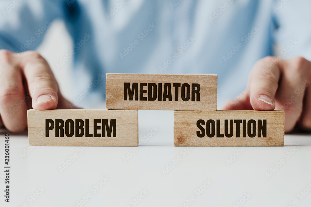Poster hand holding a wooden jigsaw puzzle with conflict and mediator word. there is a matching puzzle next