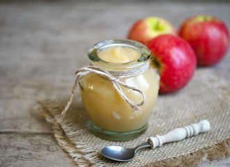 Old wooden table with fresh made Applesauce (selective focus; close-up shot) 