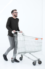 successful young man with a shopping cart