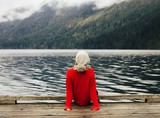 Rear view of woman sitting on pier