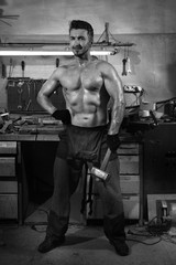 Fototapeta na wymiar Brutal man in a metalwork shop.