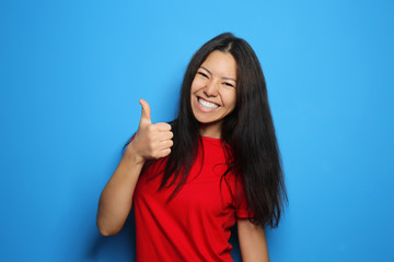 Attractive young woman posing on color background