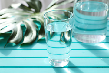 Glassware of fresh water on color table