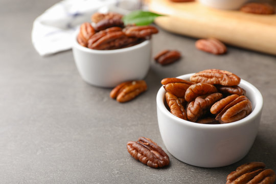 Small dish with tasty pecan nuts served on table. Space for text