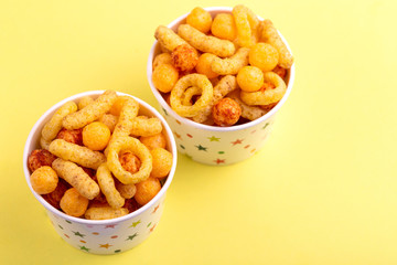 Assorted puff corn snacks in two paper cup