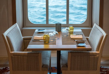 Table for two in shipboard restaurant by window