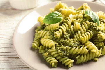 Gordijnen Plate with delicious basil pesto pasta on table © New Africa