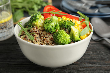 Bowl with quinoa and different vegetables on table, closeup