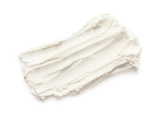 Smear of tasty cream cheese on white background, top view