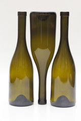 Three empty wine bottles close up on white background