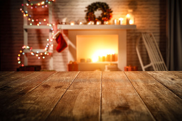 wooden table with attributes of Christmas in the glow of the fireplace   