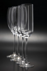 Four wine glasses on a dark background close-up