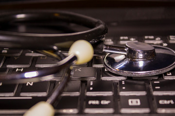 Medical Stethoscope over computer keyboard