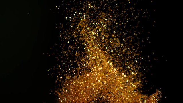 Golden glitter background in super slow motion shooted with high speed cinema camera.