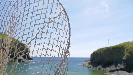 Close up of a fishing net blowing in the wind, in Cadgwith Cove, Cornwall.