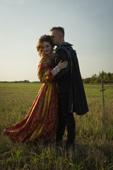 Fototapeta premium Knight with sword and girl in renaissance dress