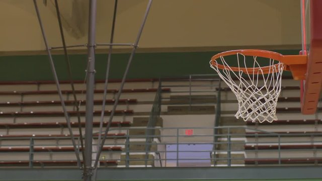 Basketball shot at basket hits the rim and rebounds away in slow motion