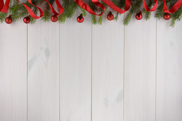 Christmas decorations, red balls on a white wooden table. Top view, copy space.