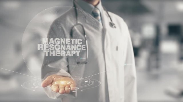 Doctor holding in hand Magnetic Resonance Therapy