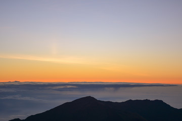 Fototapeta na wymiar Sunrise at the summit of Haleakala volcano on the island of Maui, Hawaii.
