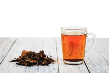 Cup of black tea and tea leaves