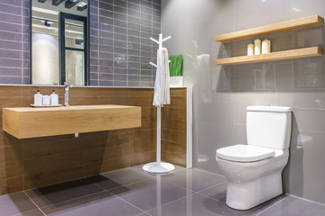 Luxury bathroom interior with toilet bowl, mirror and modern basin cabinet for home, house, building, hotel, resort