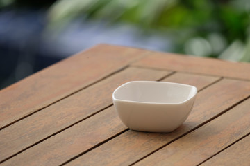 white bowl on wood table.