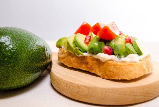 Closeup of avocado sandwich with cherry tomato