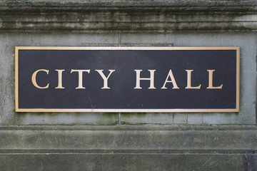 City Hall Sign on Stone Wall