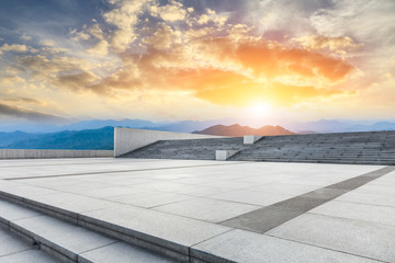 Empty floor and green mountain with beautiful clouds at sunset