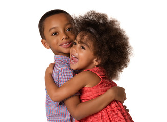 Two cheerful siblings brother and sister hugging each other, isolated