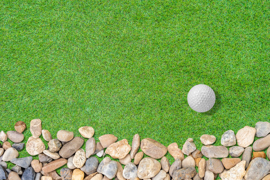 Golf ball on green with small stone on grass abstract  for background