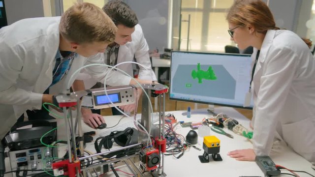 Engineers comparing detail printed with 3d printer