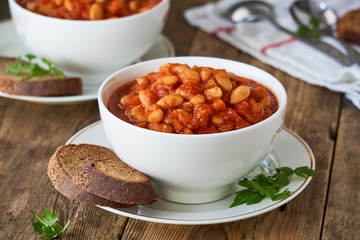Thick tomato soup with white beans and vegetables in a bowl