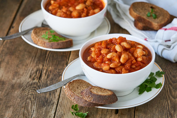 Thick tomato soup with white beans and vegetables in a bowl