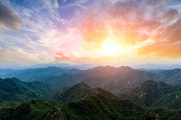 Green mountain and colorful cloud at sunset