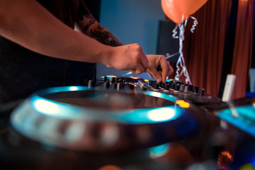 Dj playing the track in the nightclub at a party