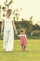 mother and little daughter playing at backyard