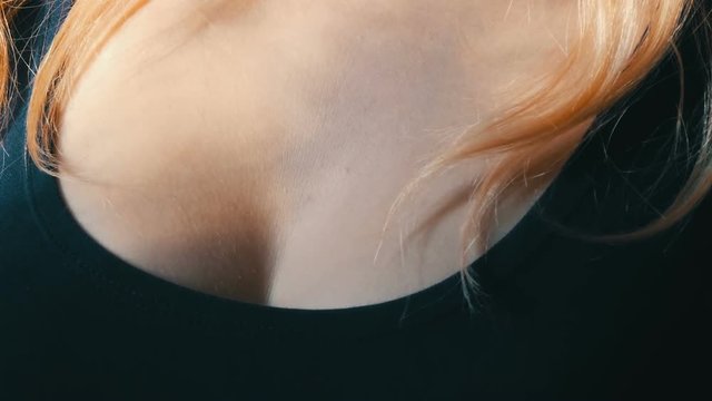 Beautiful poured breasts of young sexy girl with blond long hair. Women's neckline