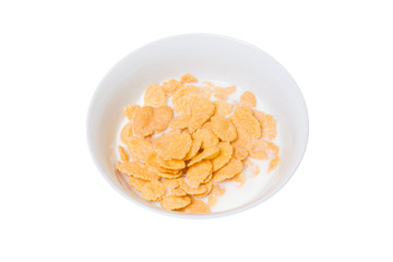 Breakfast on an isolated white background. A plate with cornflakes and milk.