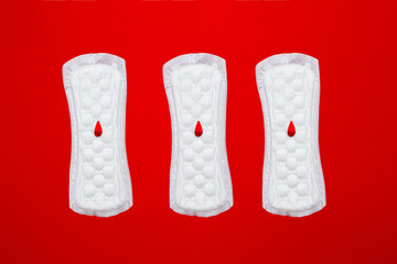 menstruation concept. a menstrual pad on red background