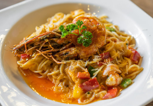 spaghetti with tiger prawn sauteed with shrimp oil in plate