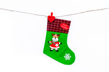 Decorative christmas socks. Empty socks for gift hanging off a thread on white background top view copy space