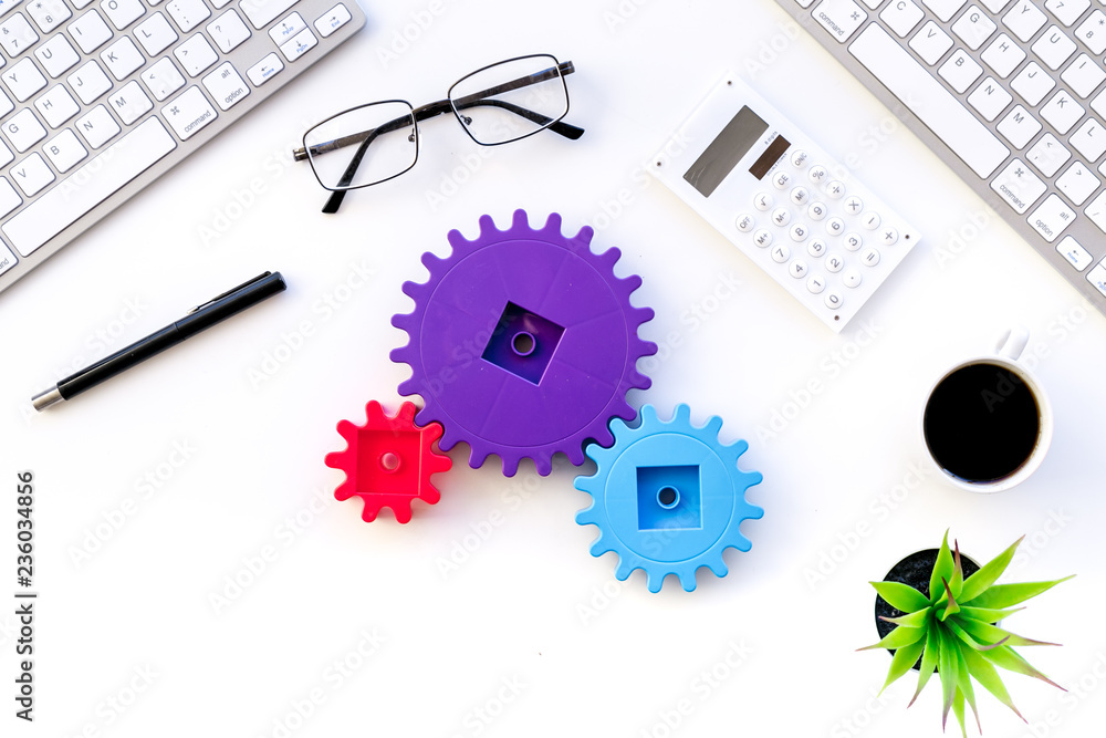 Aufkleber teamwork in business concept. toy gears on white office desk with computer keyboard top view copy sp