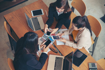 Group of teamwork using smart phone,tablet to brainstorm at office meeting room.Professional...