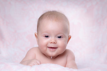 Baby girl smiling. Drooling in a child