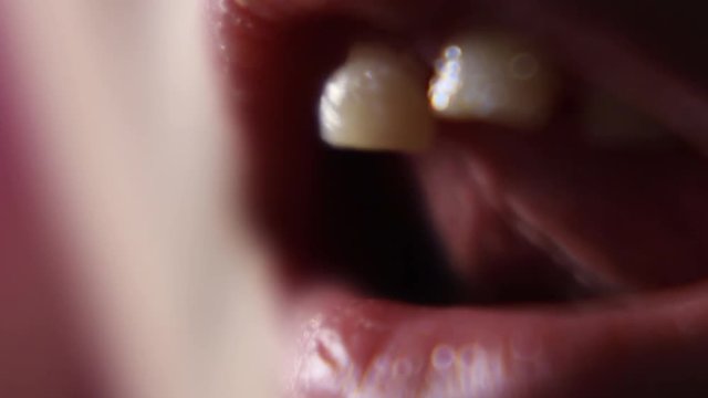 Macro Close Up Of Young Girl Wiggling Loose Front Teeth.