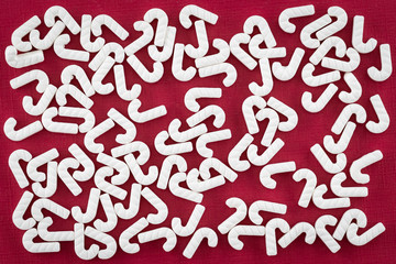 White candy cane sprinkles on a red background