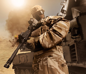 Military soldier posing with rifle in desert.