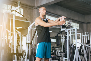 Sport man stretching hand for warming up befor doing exercises training,Cross fit body muscular workout in the gym